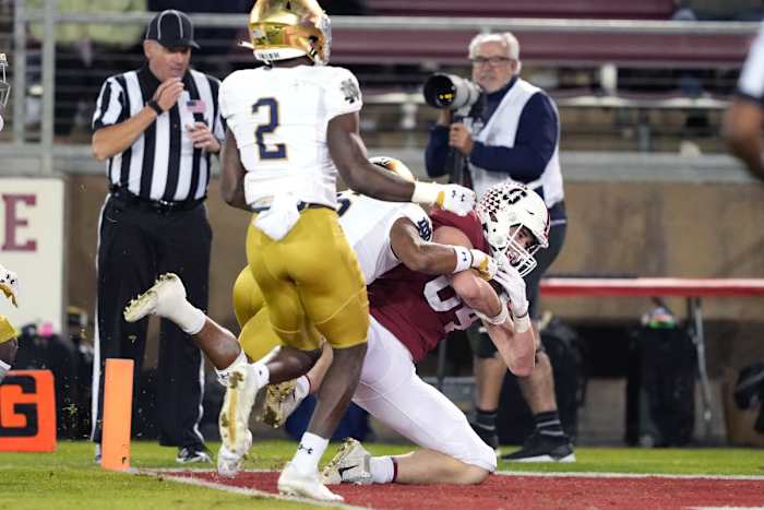 Nov 27, 2021; Stanford, California, USA; Stanford Cardinal tight end Benjamin Yurosek (84) scores a touchdown while being tackled by Notre Dame Fighting Irish cornerback Clarence Lewis (6) during the fourth quarter at Stanford Stadium. (Darren Yamashita / USA TODAY Sports).